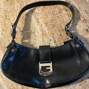 Black leather w/ silver guess buckle zipper close